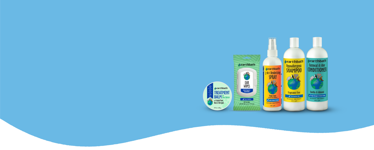 Collection of pet care products including bottles and a box on a blue background