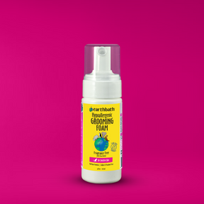 A bottle of earthbath Hypoallergenic Grooming Foam for cats on pink background