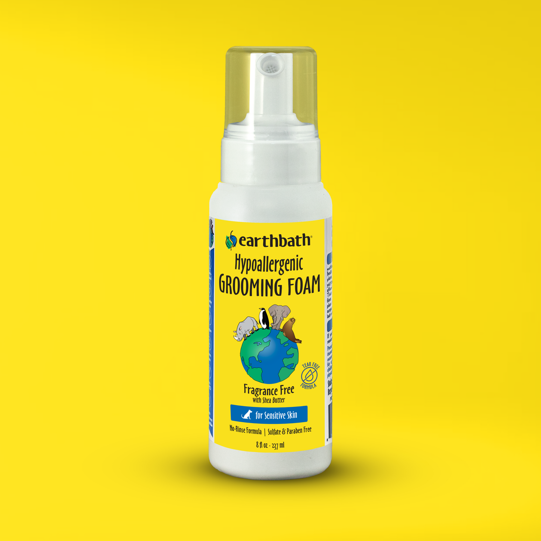 A bottle of earthbath Hypoallergenic Grooming Foam for dogs. The bottle is transparent with a white label, and the foam inside is visible on a yellow background